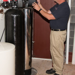 Russo employee working on a water softener unit
